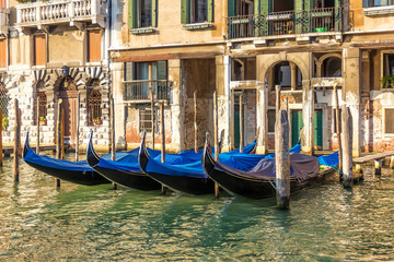 Fototapeta na wymiar Venice palace with gondolas moored, Grand Canal, Italy