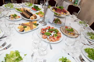 holiday table with various dishes, snacks, drinks