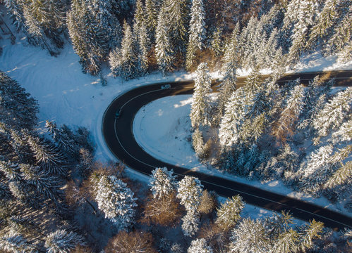 road in winter mountain landscape. Aerial view of forest