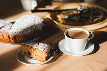 Beautiful sunny breakfast with cup of coffee and amaretto cake. 