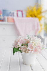 bouquet of flower at top of white wooden table