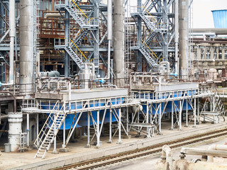 At modern chemical plant. Air cooling system with electric motors and synthesis columns of chemical...