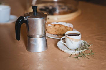 Delicious fresh morning espresso coffee made with traditional italian geyser coffee maker pot. Cup of coffee espresso with sweet cake.
