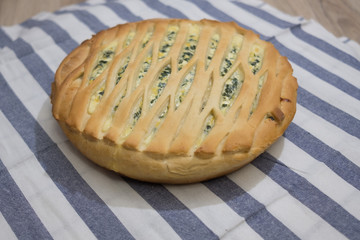 Homemade pie with cheese and herbs. Cheese pie. Homemade baking.