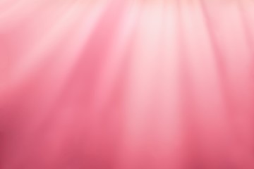 Blurred pink light background. Warm pink rays. Abstract background