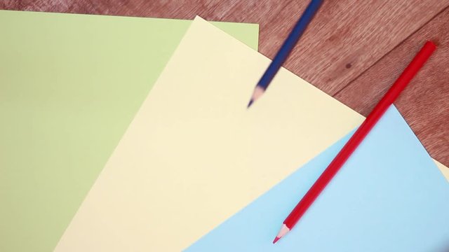 Pencils on colorful sheets of paper