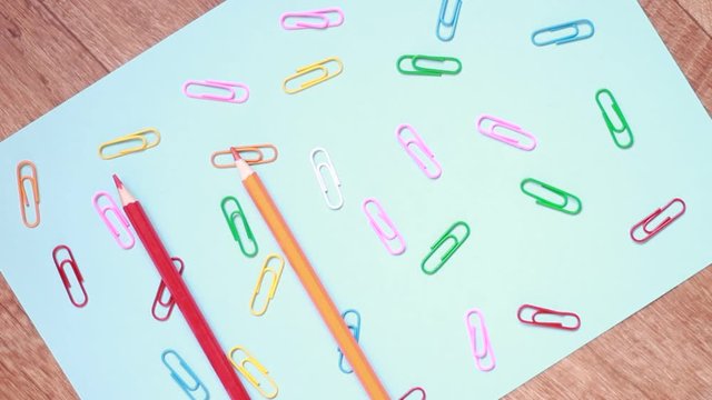 Putting multicolored pencils on multicolored paper