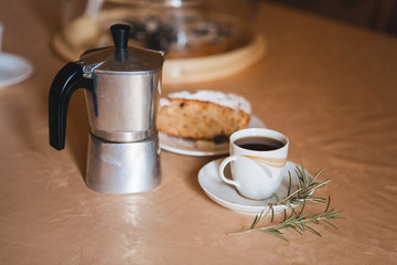 Delicious fresh morning espresso coffee made with traditional italian geyser coffee maker pot. Cup of coffee espresso with sweet cake.