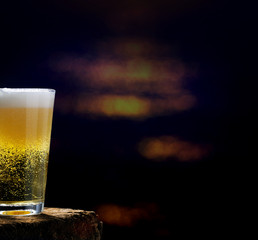 Beer, beer glass on wooden table in dark pub