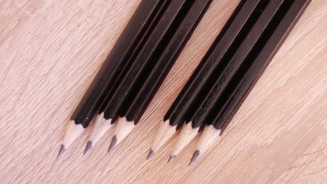 Single red pencil in range of black ones