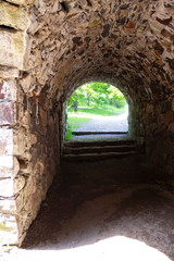 Obraz premium Stone granite ancient walls, dark rooms and archways in the historic Suomenlinna Fort Sveaborg in Finland on a summer day.
