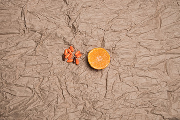Studio image of  tangerines and pills. Mandarins and orange pills.