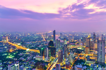 View commercial modern building and Chao Phraya river in city downtown at twilight time in Bangkok Thailand