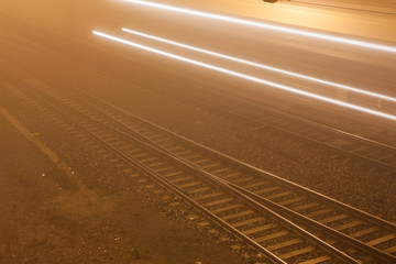 Fototapeta premium Railroad near train station at foggy night