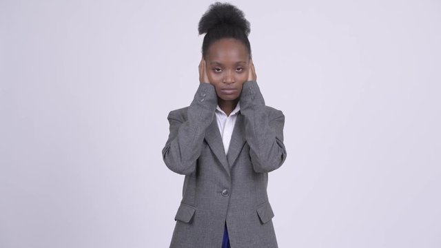 Young African businesswoman covering ears as three wise monkeys concept
