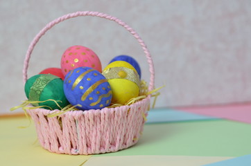 Easter, Easter egg color vibrant, spring Orthodox holiday. colorful decorated eggs in a pink basket on a background of different colors