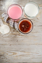 Healthy organic diet drink. Chocolate, berry and vanilla protein shakes. Non dairy protein vegan cocktails. With measuring tape. Concept of weight loss, fitness, healthy lifestyle.