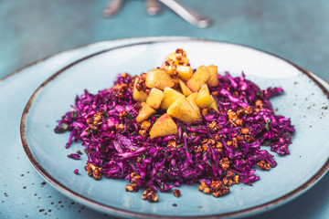 Red cabbage salad with fried apples caramelized with cinnamon