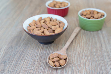 Almond nut on wood background.