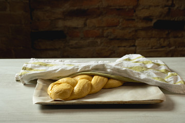Raw challah traditional jewish bread covered with linen towel. Steps food concept.