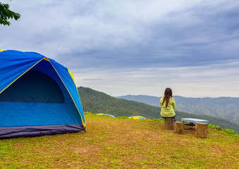 alone lady sit on seat and look out mountain view in Thai land autumn Chaingrai