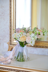 Beautiful bouquet of flowers near the mirror.