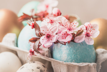 Easter eggs and spring flowers on rustic wooden background.Easter holiday card copy space.
