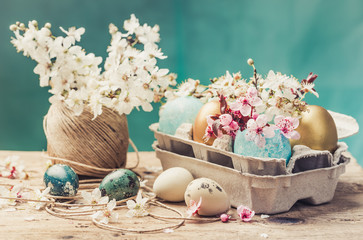 Easter eggs and spring flowers on rustic wooden background.Easter holiday card copy space.