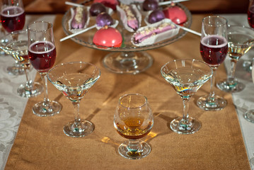 Glass glasses with colored drinks on the table. alcoholic drinks at the buffet