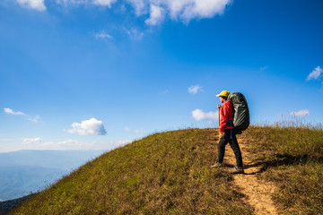 Young backpacking woman hiking on mountains. Doi Mon Chong, Chiangmai, Thailand.