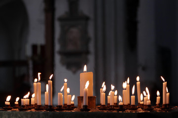 Many flames on candles lit in the church in respect. Christianity.