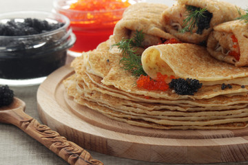 Russian pancakes with red and black caviar