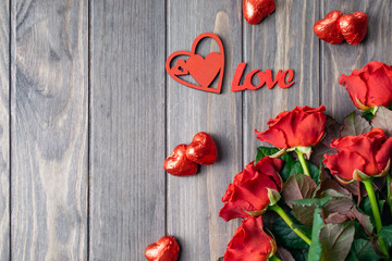 Romantic Saint Valentine wooden background card with bouquet of beatiful red roses and Love lettering