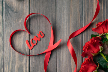 Romantic Saint Valentine wooden background card with bouquet of beatiful red roses and Love...