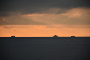 skyline at sunset and vague ships on it