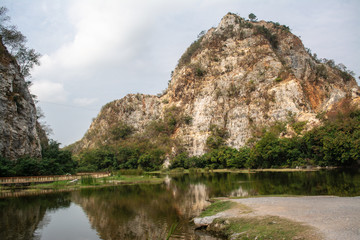 Fototapeta na wymiar Khao Ngu Rock Park natural tourist attraction not far from Bangkok originally a rock blast source later changed to a recreation place that is a beautiful view of nature, a lake in the middle of the va