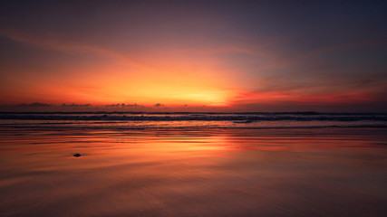 Fototapeta na wymiar sunset over the sea reflection on the sand