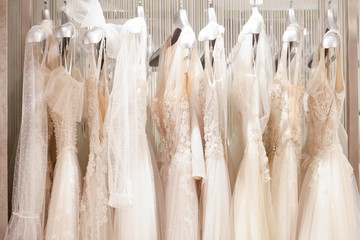 Large selection of dresses in the wedding salon. 