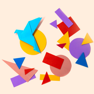 Origami blue bird and multicolored geometric shapes
