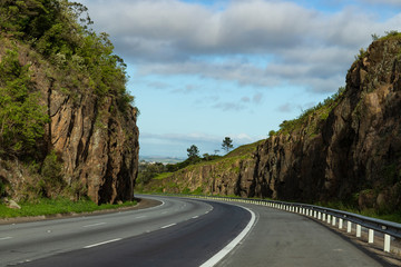 Road with stone walls on a sunny day. Highway Presidente Castelo Branco, state of Sao Paulo Brazil South America. 