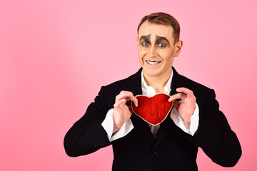 Big hearted. Happy mime falling in love. Mime man hold red heart for valentines day. Mime actor...