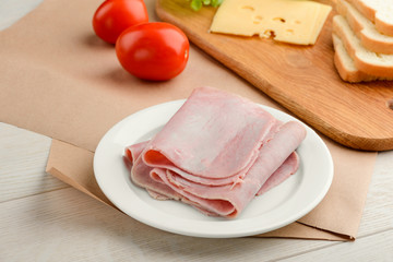 Ham slices on white plate