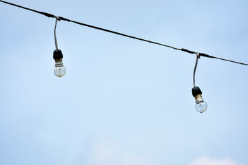 twins vintage light bulbs isoledted on blue sky background