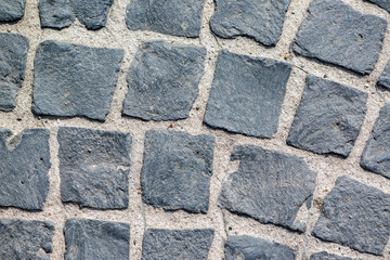 Abstract background of old cobblestone pavement view from above