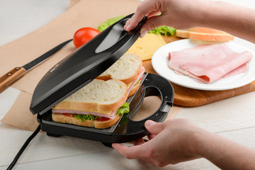 Man using a panini press