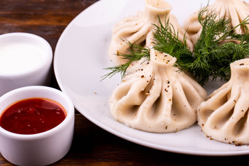 Khinkali with pork and beef, with ketchup and sour cream