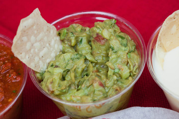 Tortilla Chip in a cup of Guacamole Mexican Food