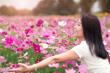 Asian woman in the cosmos field.