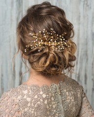 Hairstyle decorated by shiny gold hair accessory
