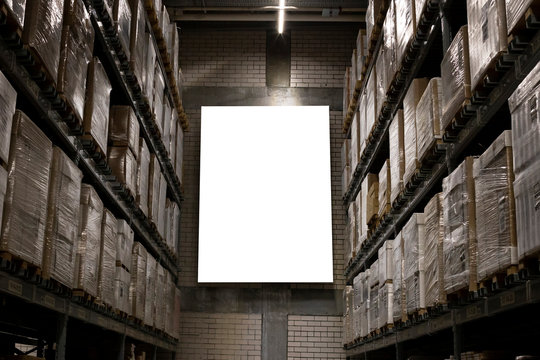 Blank Mockup Advertising With Copy Space On The Wall Of The Warehouse (storage) With Rows Of Shelves With Goods Boxes